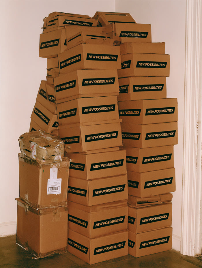 Stack of branded kraft shipping boxes in a room corner