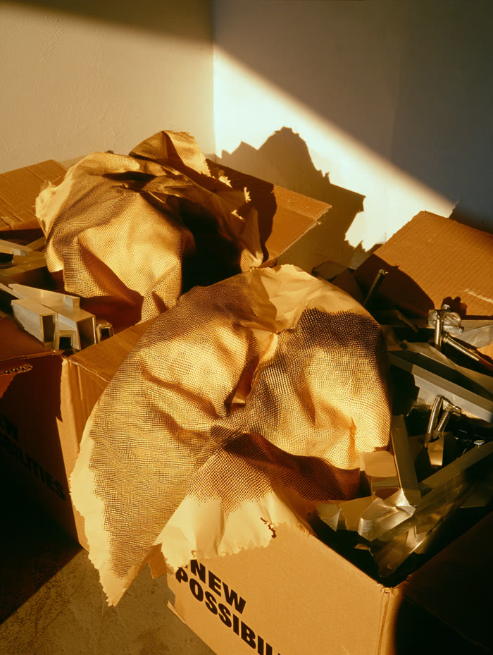 Open boxes with patterned wrapping and aluminium profiles in low sun